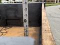 A measuring tape is positioned vertically in a truck bed showing a measurement of approximately 36 inches