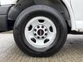 Close-up of a 2014 GMC Savana wheel showcasing the silver alloy rim and Bridgestone tire mounted on it