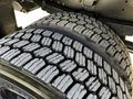 Close-up of the tire tread of a 2022 Blue Bird Vision showing deep grooves and a pattern designed for traction and stability