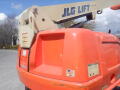 A 2008 JLG Boom Lift with a bright orange exterior and a raised extendable arm featuring the JLG logo and safety instructions