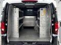 Interior view of a 2019 Mercedes-Benz Metris cargo van showing metal shelving and storage compartments without any cargo inside