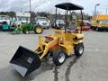 A yellow 2024 AGT Industrial KRW23 Mini Loader with a front bucket attached and a covered seat for the operator