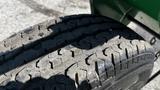 Close-up of a tire from a 2017 Laymor SweepMaster 300 showcasing its tread pattern and wear