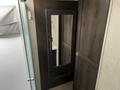 A mirrored cabinet with a dark wood finish and a small drawer, designed for use in a recreational vehicle bathroom