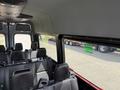 Interior view of a 2019 Mercedes-Benz Sprinter van showing rows of seats with safety belts and a panoramic window