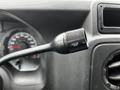 A close-up of a black control knob labeled with numbers indicating settings attached to a dashboard of a 2009 Ford Econoline