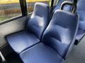 Two blue upholstered seats in a 2018 Chevrolet Express, featuring a smooth texture and ergonomic design for passenger comfort