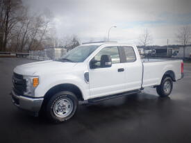 A white 2017 Ford F-250 pickup truck parked at an angle showing its side and front, featuring a standard bed and chrome wheels