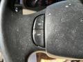 A close-up of the steering wheel of a 2000 Ford Motorhome showing buttons labeled ON and OFF with a worn, textured surface
