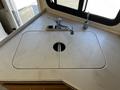 A sink with a polished surface featuring a circular opening and a sleek chrome faucet in a 2000 Ford Motorhome