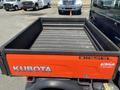 A 2014 Kubota X1100C utility vehicle with a bright orange and black cargo bed labeled Diesel