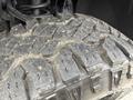 Close-up of a rugged tire tread from a 2017 Chevrolet Silverado 1500 showcasing deep grooves and a worn surface