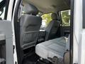 Interior view of a 2016 Ford F-550 showing the back seat with gray fabric upholstery and headrests adjusted upward