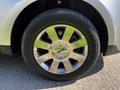 Close-up of a shiny chrome wheel with a Lincoln logo center cap on a 2013 Lincoln MKT tire