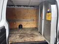 2022 GMC Savana van interior featuring a wooden floor and a partition with a security grid and warning sign about load security