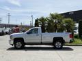 A silver 2016 Chevrolet Silverado 2500HD pickup truck is shown from the side with a single cab and chrome wheels