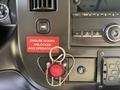 A 2020 Chevrolet Express dashboard featuring a red "FIRE" button with a keyring and a red warning sign stating "ENSURE DOORS UNLOCKED AND OPERATIONAL"