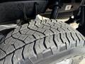 Close-up of a tire on a 2015 Toyota Tacoma showing tread pattern and rubber texture