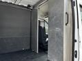 Interior of a 2022 Ford Transit showing a partitioned cargo area with a single front seat visible