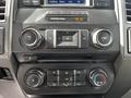 Dashboard controls of a 2017 Ford F-250 including radio, volume, and climate control buttons