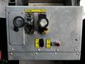 Control panel of a 2010 Freightliner M2 106 featuring levers and buttons for operating the dump box and tailgate along with other controls