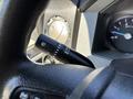 Close-up of the steering column of a 2016 Ford F-550 showing the windshield wiper control stalk and a part of the instrument cluster