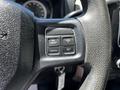 A close-up of the steering wheel controls of a 2015 RAM 5500 featuring buttons for on/off, resume, cancel, and set functions