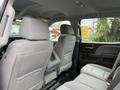 Rear seating area of a 2016 GMC Sierra 1500 featuring two headrests and a center console with armrest