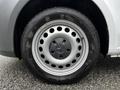 A close-up of the wheel of a 2023 Mercedes-Benz Metris featuring a silver rim with circular holes and a black tire with visible tread patterns