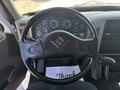 Steering wheel of a 2018 International DuraStar with various gauges and controls visible on the dashboard