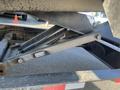 Close-up view of a hydraulic lift mechanism of a 2024 Southland 18 Foot Dump Trailer showing metal components and connection points