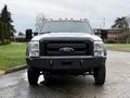 A 2016 Ford F-550 Super Duty with a black front bumper and a white body facing directly towards the viewer