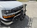 A 2017 Chevrolet Express with a front-mounted accessory rack attached to its grille