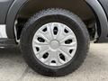 Close-up of a silver wheel with a Goodyear Wrangler tire mounted on a 2023 Ford Transit