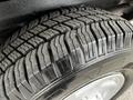 Close-up of a tire from a 2011 Ford Econoline showcasing its tread pattern and rubber texture