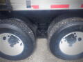 Close-up of the rear dual tires of a 2016 International WorkStar 7500 showing rugged tread and white rims