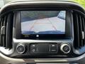 A 2021 Chevrolet Colorado's dashboard display showing a rearview camera feed with guidelines for parking assistance