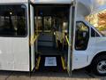 A 2017 Chevrolet Express with open doors, featuring yellow handrails and a step welcoming passengers with a sign that says Thank You for Riding with Us