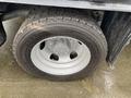 A close-up of a 2014 RAM 5500 tire featuring a large tread pattern and a silver wheel rim