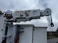 A 2011 Western Star Trucks 4900 featuring a large white crane arm with warning labels and a hook attached at the end