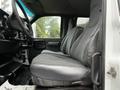 Interior view of a 2005 GMC C5 Duramax with gray upholstered front seats and a black dashboard