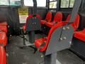 Interior seating of a 2023 Prinoth Panther T6 featuring red seats with safety belts in a row