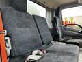 Interior view of the front seats of a 2018 Hino 195 with fabric upholstery featuring a textured pattern and safety seatbelts attached