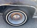 Close-up of a vintage 1982 Mercury Grand Marquis wheel showcasing a chrome hubcap and whitewall tire