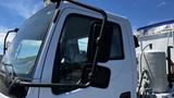 A 2006 Ford LCF 550 truck cab showing the driver's side mirror and door with a close-up view of the window and body design