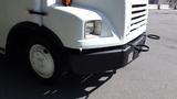 Front view of a 2004 Freightliner MT45 with a white body black bumper and round tow hooks visible on the front