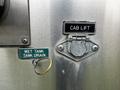 Close-up of control panel components on a 2009 Spartan Gladiator featuring a "Wet Tank Drain" label and a metal latch for "Cab Lift"
