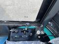 2024 AGT Industrial Green QH13R Mini Excavator control panel featuring switches and a joystick for operation