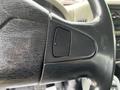 Close-up of the steering wheel of a 2011 International 4400 featuring a textured black surface and a button embedded in the spoke