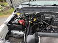 Engine compartment of a 2015 Ford F-350 SD showcasing the battery and various components including hoses and cables